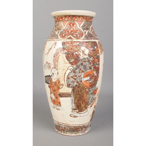 63 - A Japanese Meiji period baluster shaped Satsuma vase. Decorated with figures. Height 24.5cm.