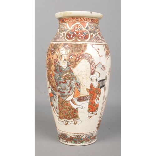 63 - A Japanese Meiji period baluster shaped Satsuma vase. Decorated with figures. Height 24.5cm.