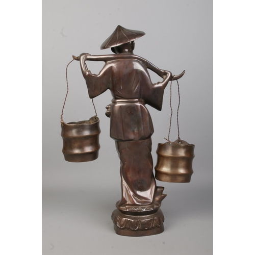 70 - A bronze statue modelled as a Chinese water carrier. Height 46cm.