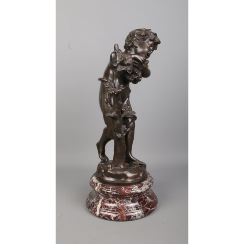 71 - After Auguste Moreau, a bronze sculpture of a boy next to a tree, raised on marble base. Signed to b... 