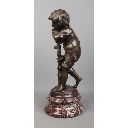 71 - After Auguste Moreau, a bronze sculpture of a boy next to a tree, raised on marble base. Signed to b... 