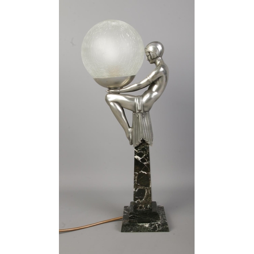 76 - After Max Le Verrier (1891–1973), an Art Deco style table lamp formed as a female figure in a seated... 