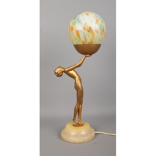 77 - An Art Deco style bronzed figural table lamp depicting a woman with outstretched arms holding a sphe... 