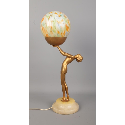 77 - An Art Deco style bronzed figural table lamp depicting a woman with outstretched arms holding a sphe... 