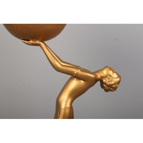 77 - An Art Deco style bronzed figural table lamp depicting a woman with outstretched arms holding a sphe... 