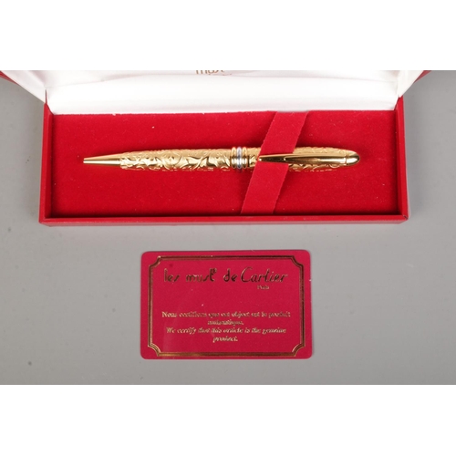 85 - Le Must De Cartier, a gold plated ball point pen with box and authenticity card.