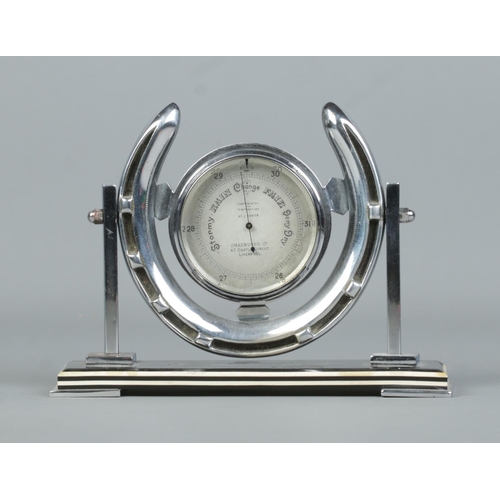 86 - A Chadburns Art Deco desk barometer set in chrome horseshoe stand. Height 13cm.