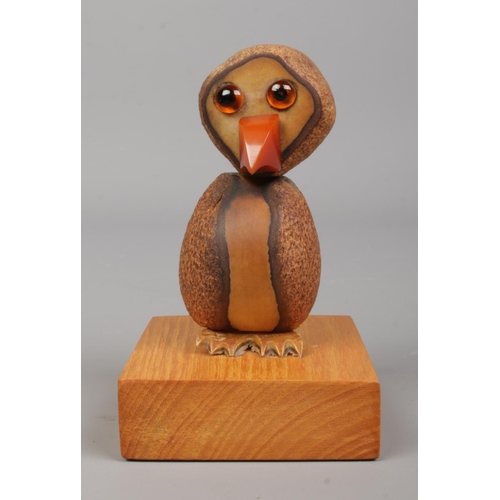 87 - A vintage YZ style Tagua nut bird on oak plinth. Height 10cm.