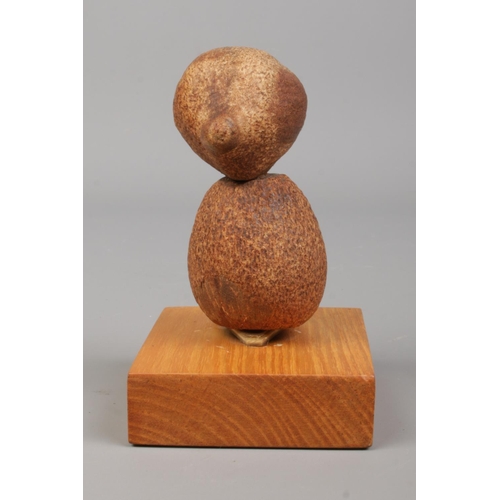 87 - A vintage YZ style Tagua nut bird on oak plinth. Height 10cm.