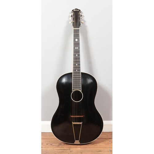 99 - A vintage Milner acoustic guitar. Having black body, white trim and mother of pearl inlay to fret bo... 