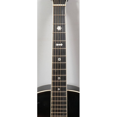 99 - A vintage Milner acoustic guitar. Having black body, white trim and mother of pearl inlay to fret bo... 