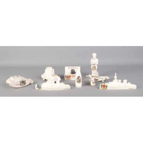 497 - A collection of military and World War themed crested ware, to include Corona China plane, Carlton C... 