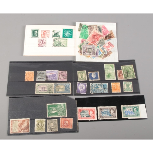 505 - A collection of vintage and antique world stamps. Includes Canadian War Tax one cent, Nouvelles Hebr... 