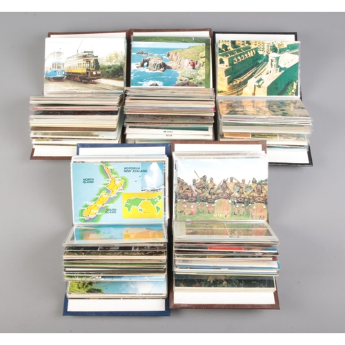 506 - Five small albums of vintage postcards contained in several albums, including examples of English to... 