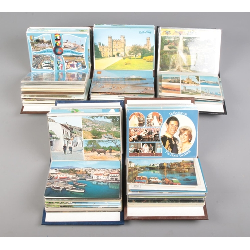 506 - Five small albums of vintage postcards contained in several albums, including examples of English to... 