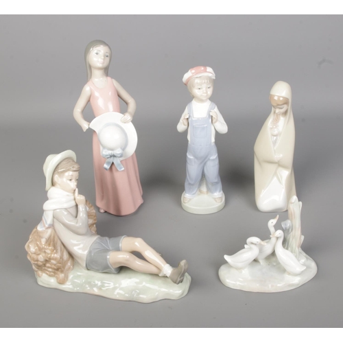 514 - Five Lladro and one Nao by Lladro ceramic figures to include mother and child, boy resting against l... 