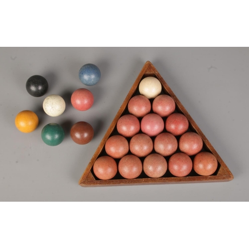 526 - A complete set of vintage snooker balls along with wooden triangle rack.