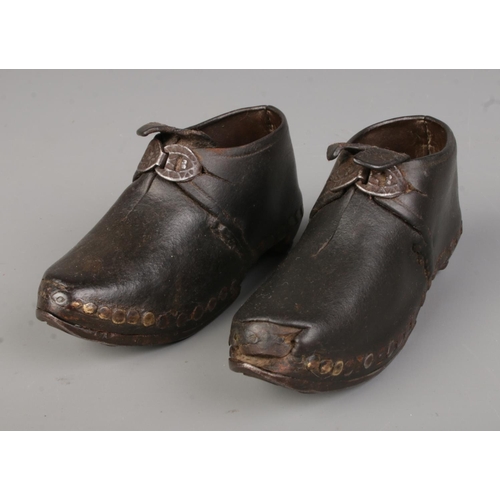 530 - A pair of antique of child's shoes featuring leather upper studded into horseshoe sole. Approx. leng... 