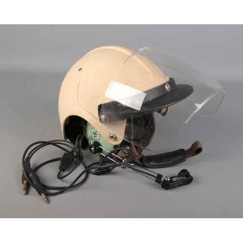 552 - An aviation helmet with Bob Heath visor and David Clark headset.