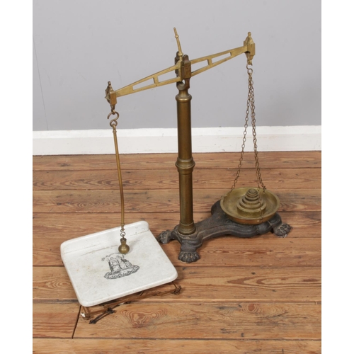 555 - A set of vintage weighing scales produced by CWS of Manchester on cast iron base with ceramic weighi... 