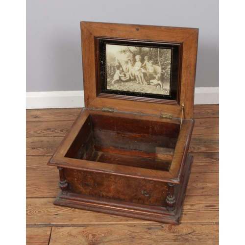 556 - A 19th century table Symphonion walnut case featuring brass mounts and floral inlaid top.