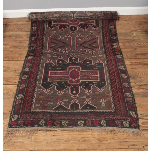 558 - A small ground wool rug featuring fringed edges and geometric design. Approx. dimensions 165cm x 95c... 