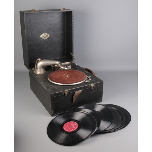 560 - A Gilbert portable record player with a small selection of records.