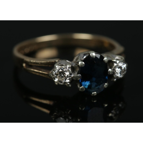 572 - A 9ct gold Sapphire and Diamond three stone ring. Size L. 2.46g