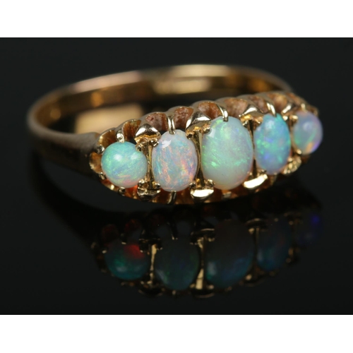 574 - An 18ct gold five stone opal ring

3.34g
Size R1/2