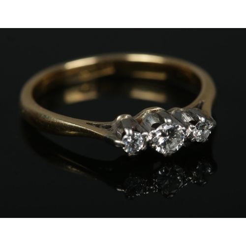 576 - An 18ct gold three stone diamond ring.

2.16g
Size J