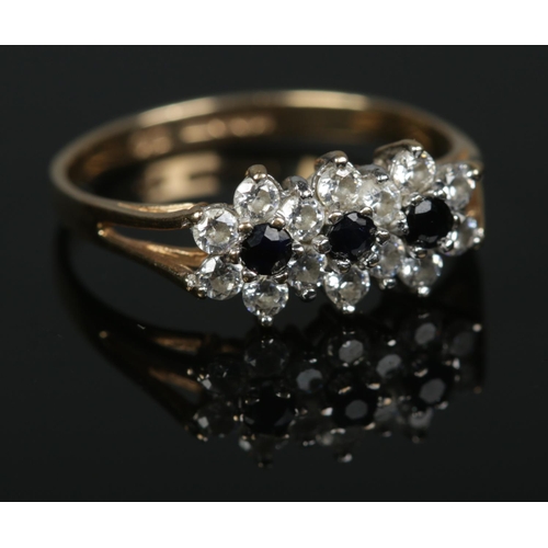 583 - A 9ct gold sapphire and cubic zirconia cluster ring. 1.47g. Size K.