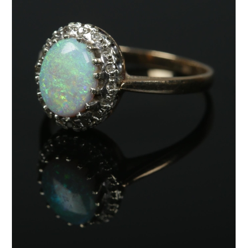 588 - A 9ct gold ring set with large central opal cabochon stone within a moissanite surround. Size S, 3.1... 