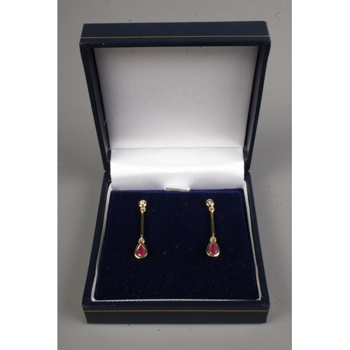 592 - A pair of 9ct gold, ruby and diamond drop earrings. 2.44g.