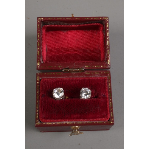 593 - A pair of white gold cubic zirconia solitaire ear studs