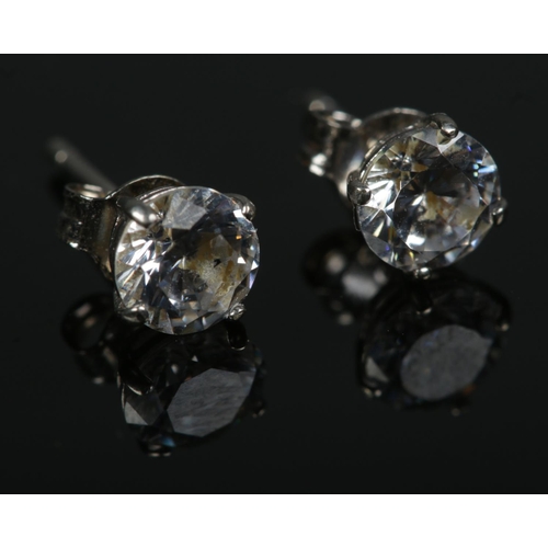 593 - A pair of white gold cubic zirconia solitaire ear studs