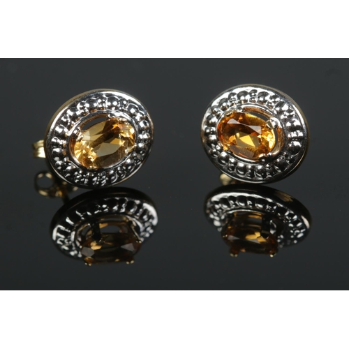 594 - A pair of 18ct gold citrine earrings 

1.2g