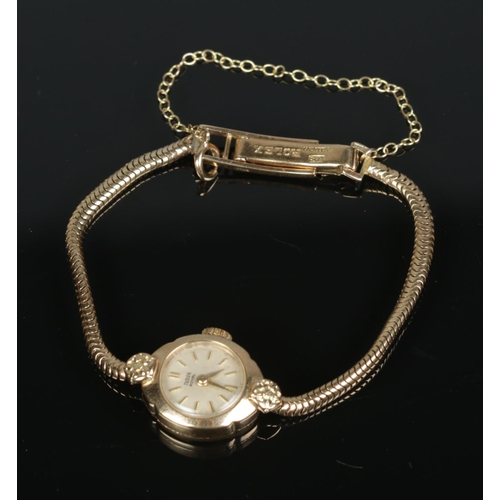 597 - A 9ct gold Tudor Royal ladies wristwatch having baton markers on a snake link chain, bracelet is sta... 