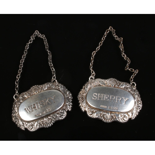 606 - Two silver decanter labels including Whisky and Sherry examples assayed Birmingham 1976 and 1978.

T... 