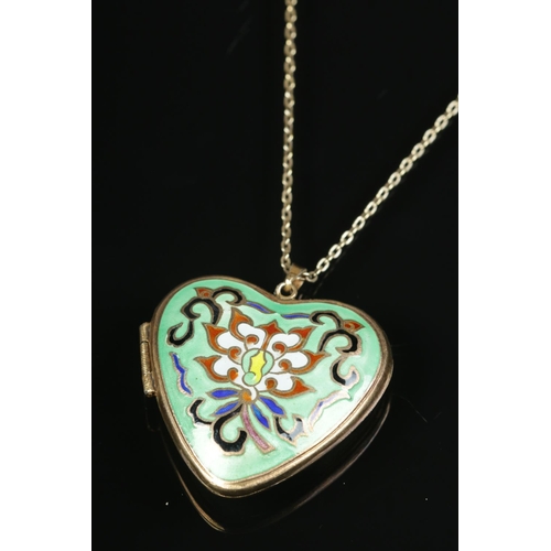 609 - A heart shaped enamel and silver gilt locket on chain