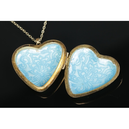 609 - A heart shaped enamel and silver gilt locket on chain