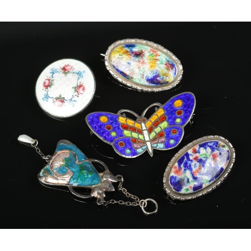 618 - A collection of enamelled silver brooches and a pendant.