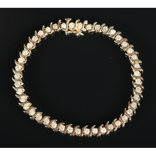 630 - A 10ct gold and diamond bracelet set with 44 diamonds.

Length 19cm unclasped 
Weight 9.96g