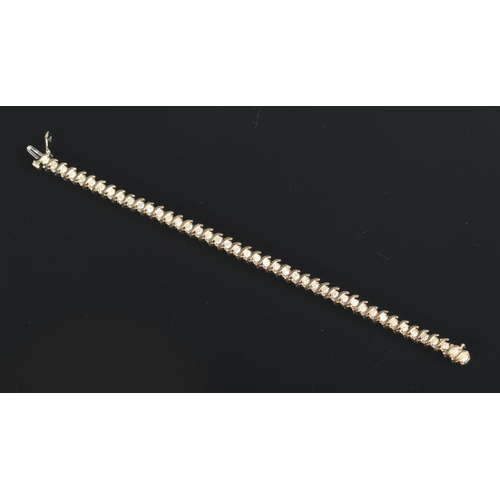 630 - A 10ct gold and diamond bracelet set with 44 diamonds.

Length 19cm unclasped 
Weight 9.96g