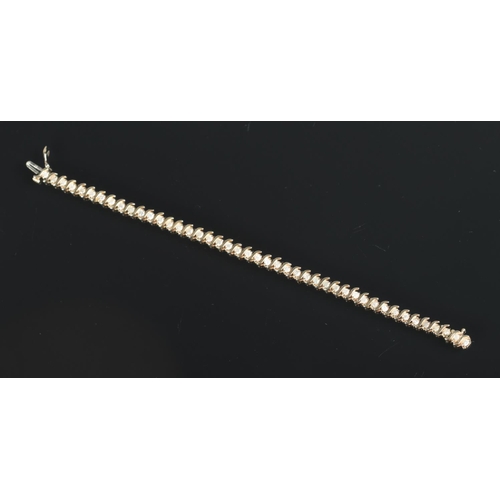 630 - A 10ct gold and diamond bracelet set with 44 diamonds.

Length 19cm unclasped 
Weight 9.96g