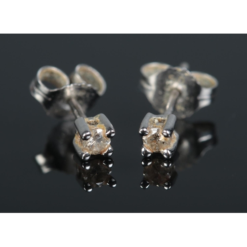 648 - A pair of 10ct white gold diamond stud earrings.

0.62g