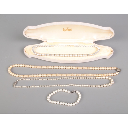 656 - A collection of cultured and simulated pearl necklaces most featuring silver clasps and one with 10c... 