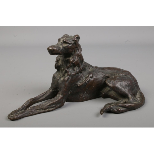 668 - A good quality heavy bronze sculpture of a reclining dog

Length 20cm