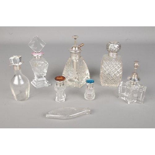 669 - A good collection of mostly silver topped perfume/scent bottles to include J&R Griffin and Henry Per... 