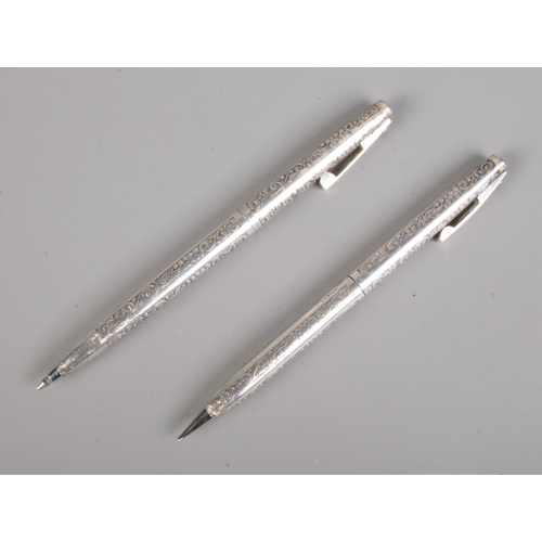 671 - A cased Sheaffer sterling silver propelling pencil and ball point pen set featuring floral engraving... 