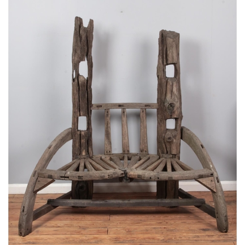 675 - A rustic reclaimed driftwood two seat garden bench. Height: 166cm, Width: 155cm.